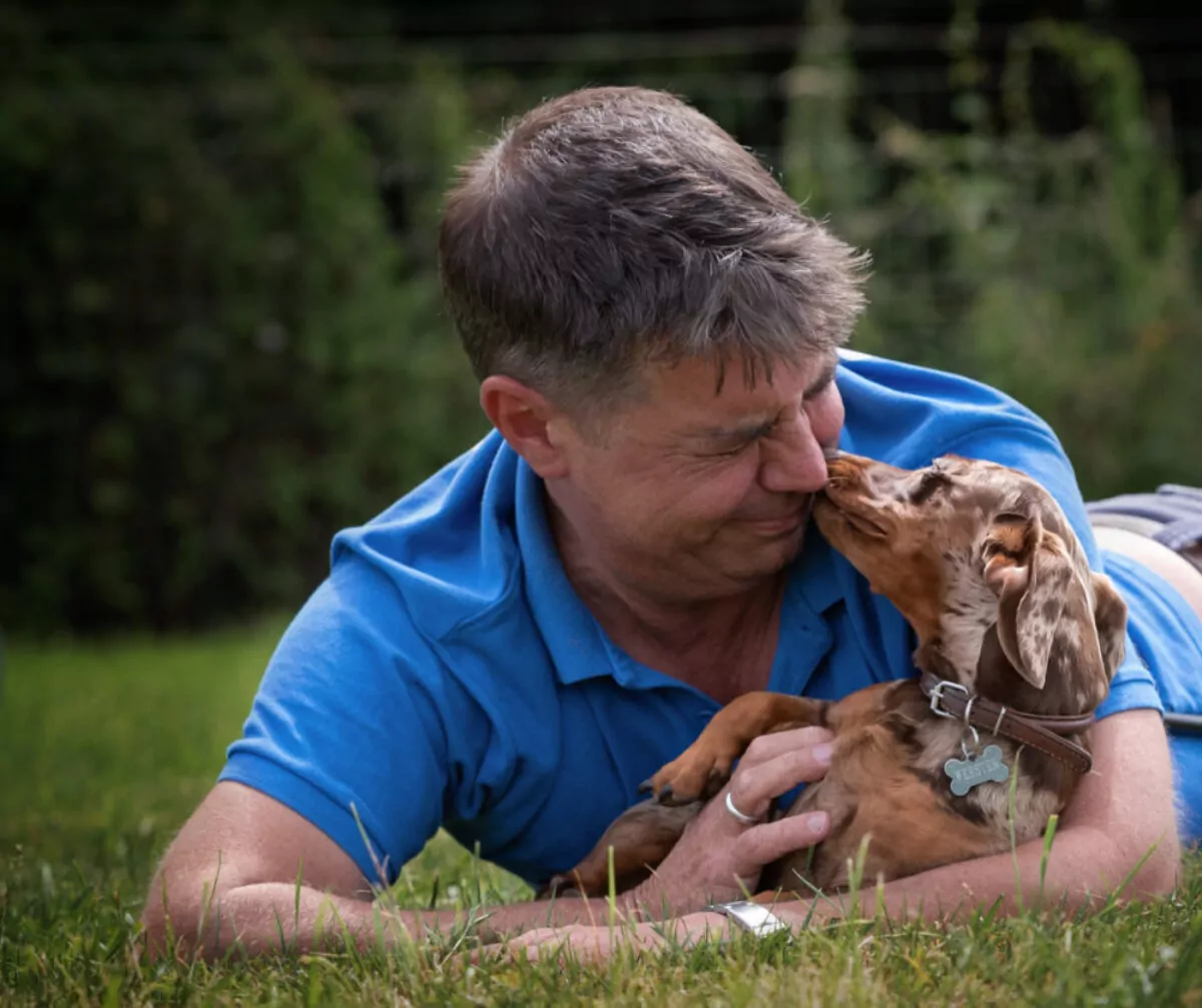 Simon Bruce's Centre Manager getting licked by a Dachshund
