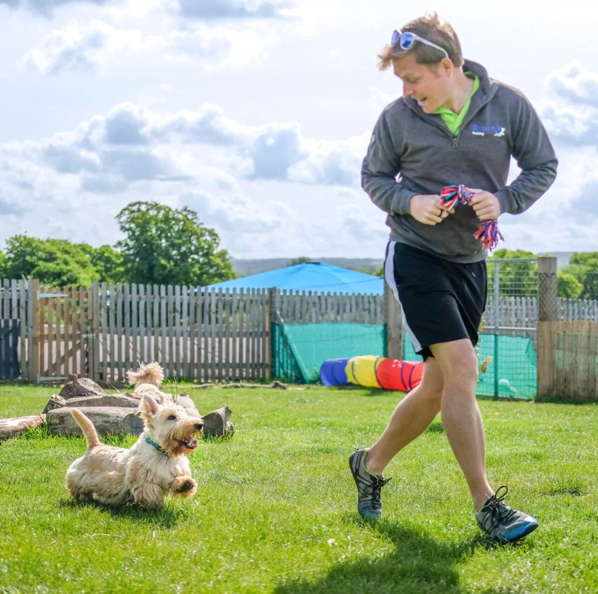 Bruce’s team member during dog training while running alongside a terrier dog