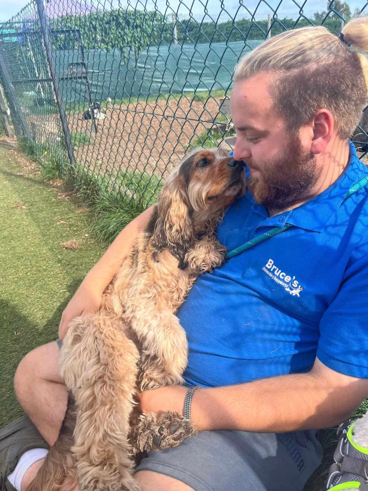 dog having a cuddle with day care staff